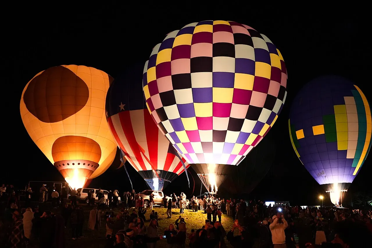 Hot air balloons lit up at night during Carolina BalloonFest in Statesville, North Carolina