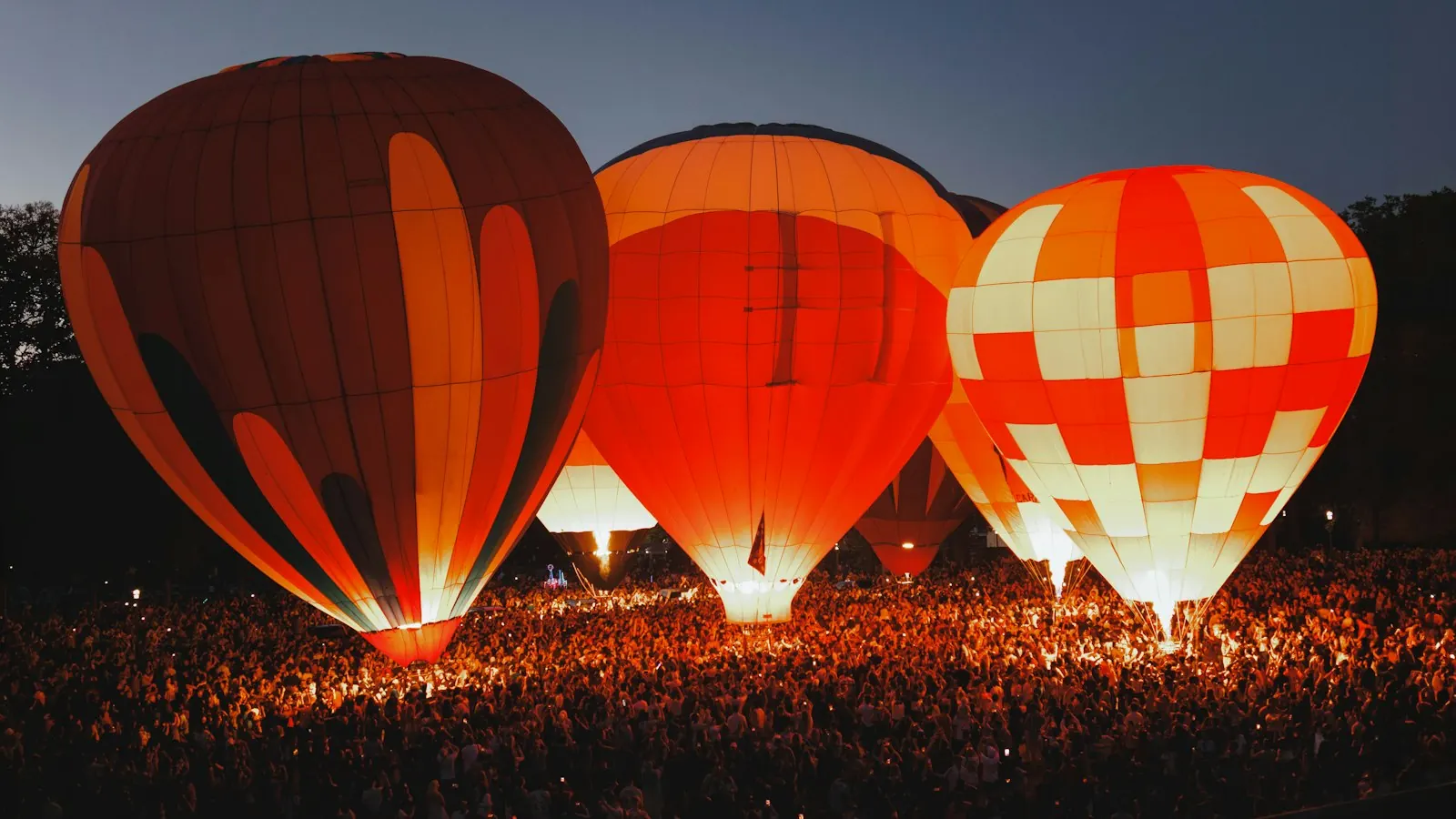 Hot air balloons glowing at night at Seattle Center